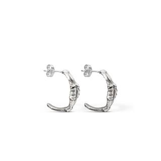 Recycled sterling silver midi hoop earrings with an organic surface by Lunaflux on a plain white background.
