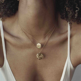 Model showcasing the Empreinte pendant necklace handcrafted by Claire Hibon from reused and recycled material.