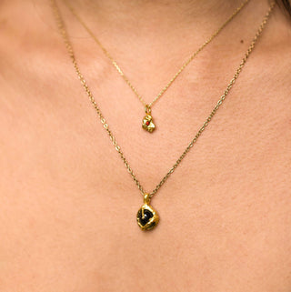 Close up of model wearing gold-plated green tourmaline Rhea pendant necklace