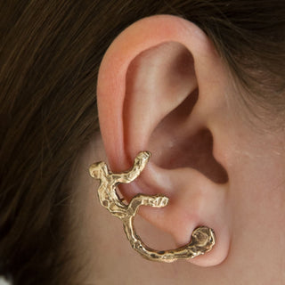 Model wearing recycled brass monkey cuff earring