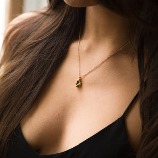 Model wearing green tourmaline gold-plated Rhea necklace