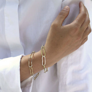Model wearing two recycled sterling silver and brass chain bracelets with large links