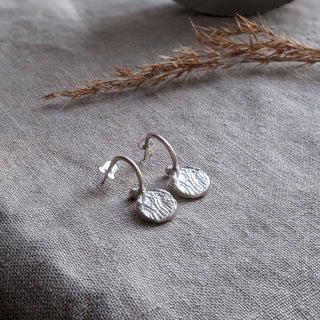 Lamina drop earrings in sterling silver handmade by Lunaflux on a linen background.