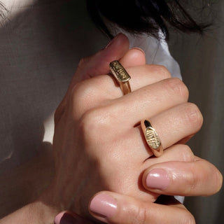 Model wearing the Lumina signet ring made from brass by Lunaflux.