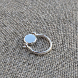 The Ingot spinning ring in sterling silver handmade by Lunaflux on a linen background.