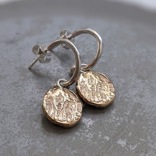 Lamina drop earrings in brass and sterling silver handcrafted by Lunaflux on an organic background.