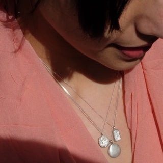 Model wearing the Sophia pendant by Lunaflux handmade from recycled silver in a set.