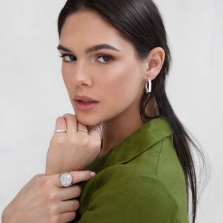 Model wearing sustainable silver jewellery featuring Portus hoops handmade by Lunaflux.
